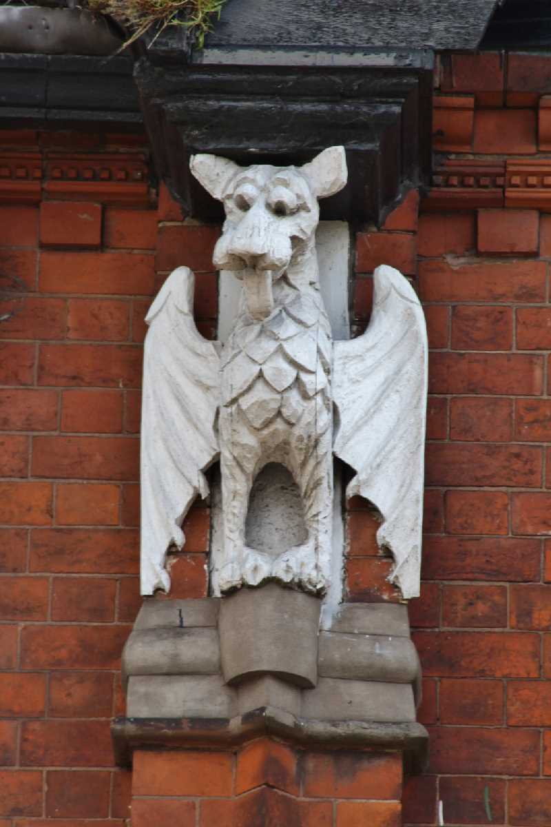 Griffin (?) looking down on Kings Heath shoppers.